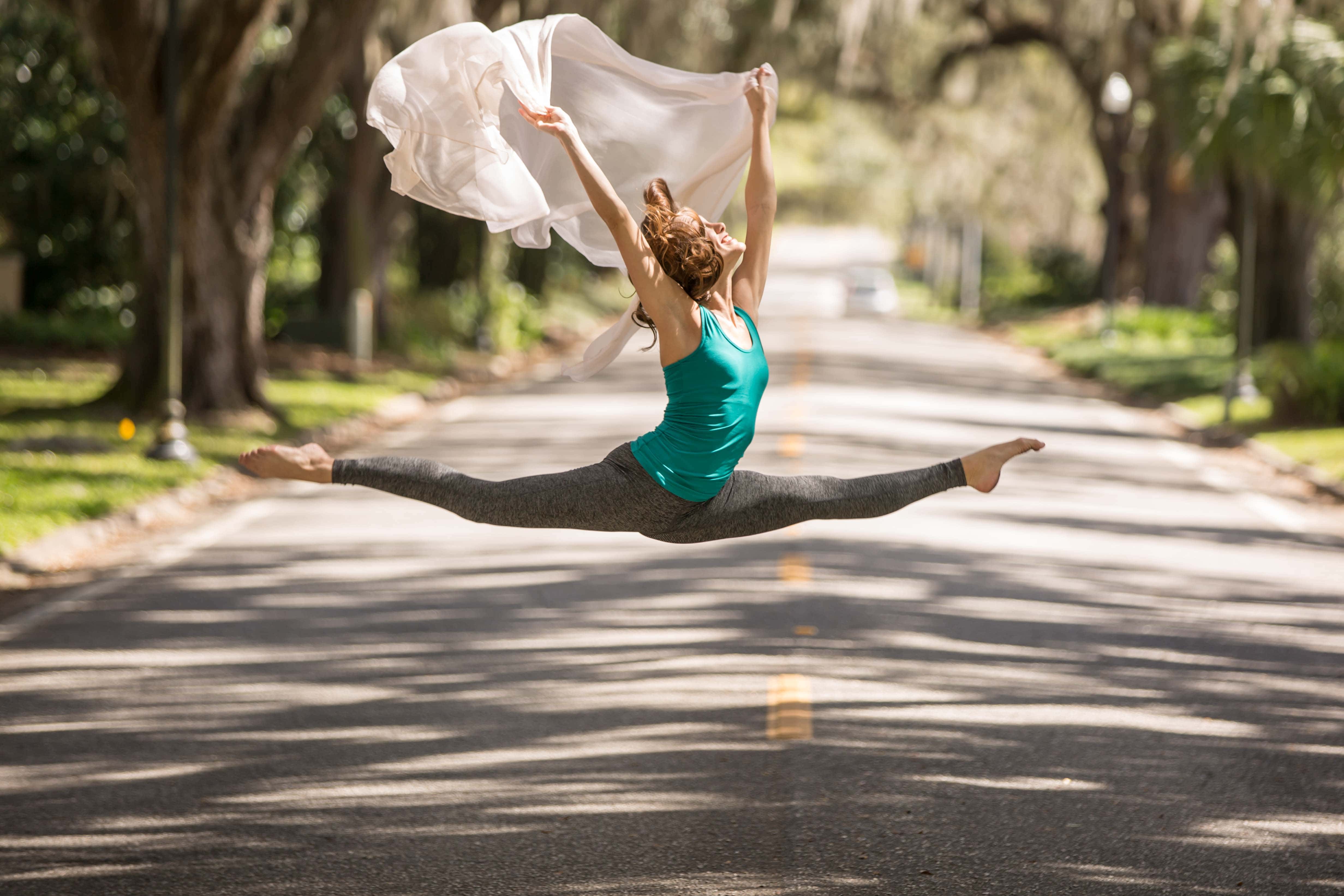 senior leaping in street in ocala photo