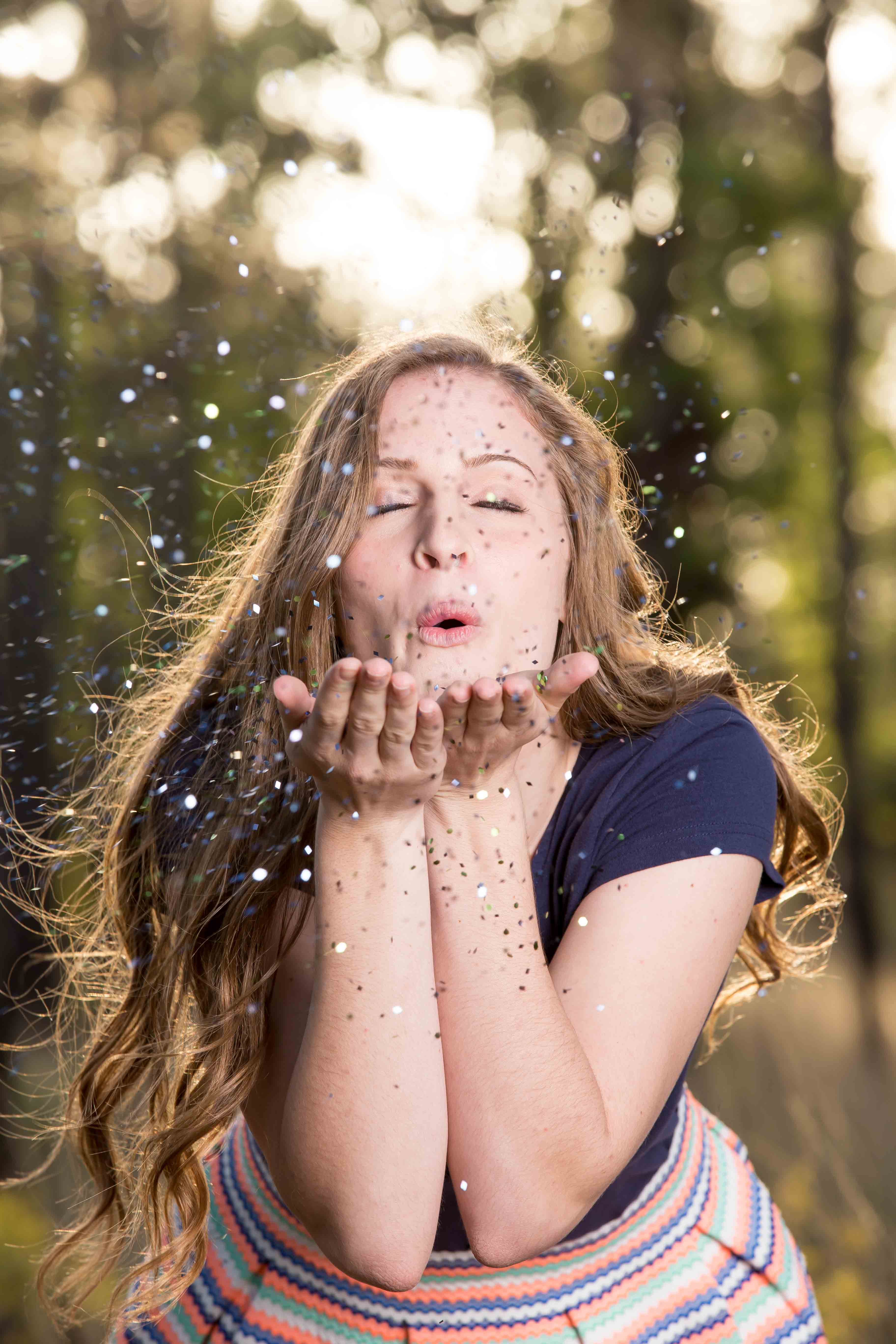 senior girl blowing glitter in ocala