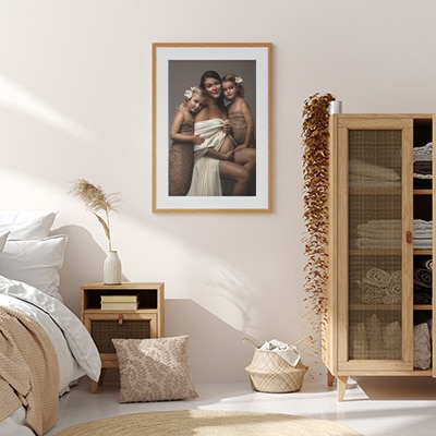 room view of serene bedroom displaying a maternity portrait with daughters